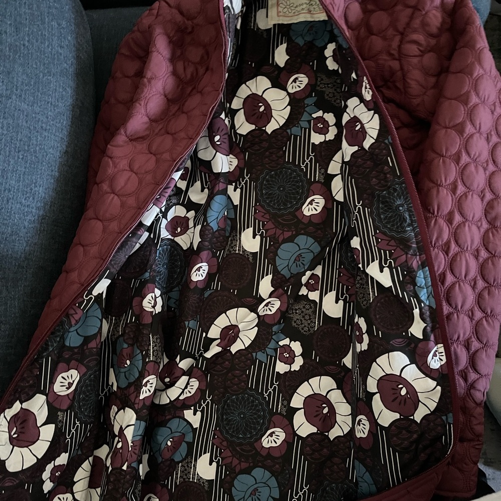 Small, long (thighs) burgundy jacket with floral pattern inside.